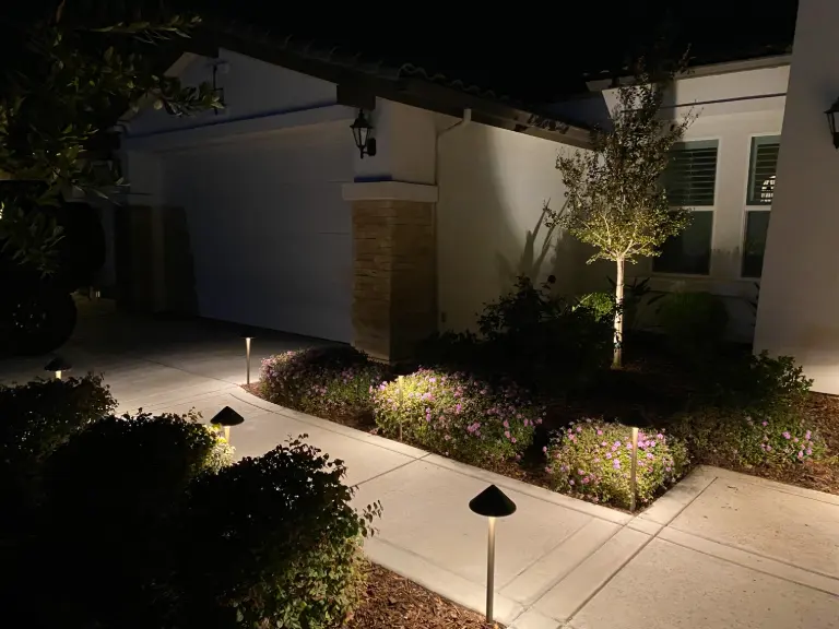 Front walkway with shielded path lights and illuminated planting